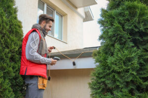 christmas lights man decorating roofing lights